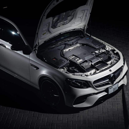 Mercedes E63 AMG Motorraum mit offenem Carbon-Ansaugsystem, Tuning Zubehör, Nachtaufnahme